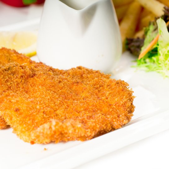 Свинячий биток в картопляному паніруванні