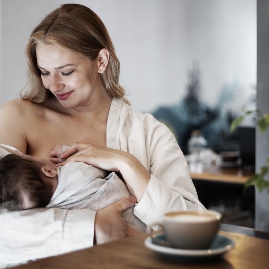 Жінка годує дитину грудьми